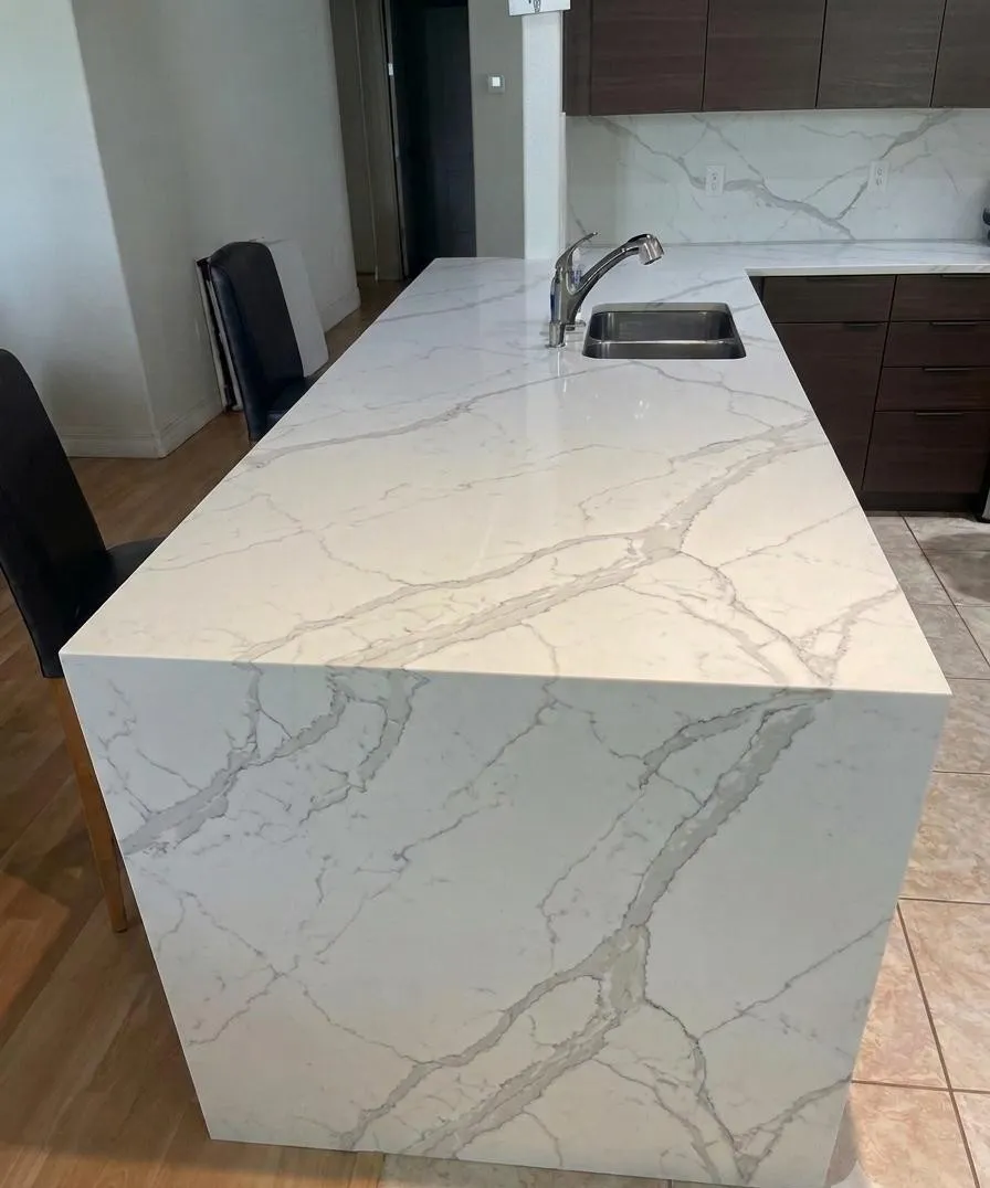 Kitchen island with waterfall quartz, a Yoll Remodeling remodel in Orlando